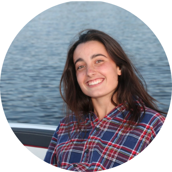 Image of a woman smiling with water in the background.