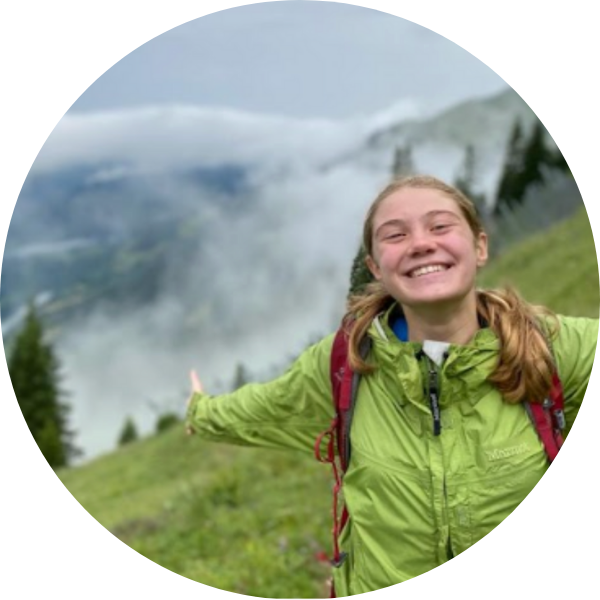 Headshot of Emma Hack with a mountain in the background