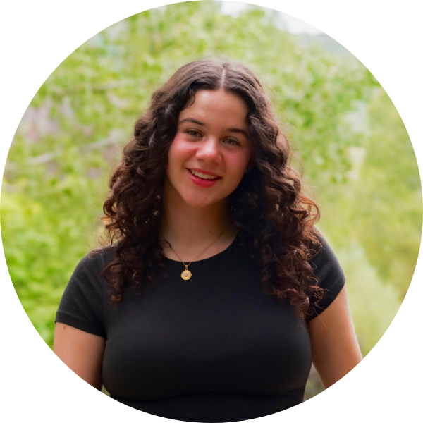 Photo of a person (Erika) standing with green background.