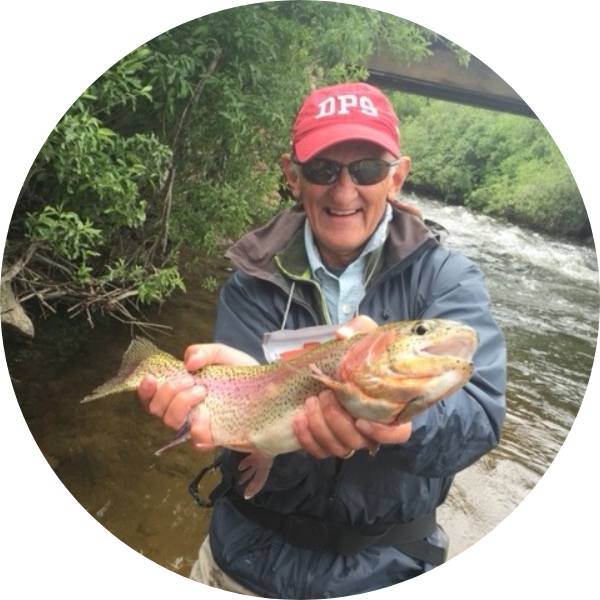 Headshot of Lee White holding a fish and smiling.