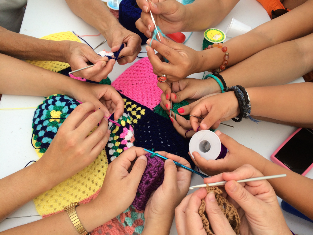 Hands holding craft materials over a table