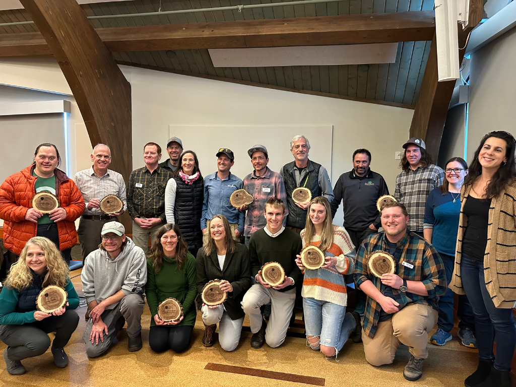 Image of a group of award recipients smiling and holding their awards.